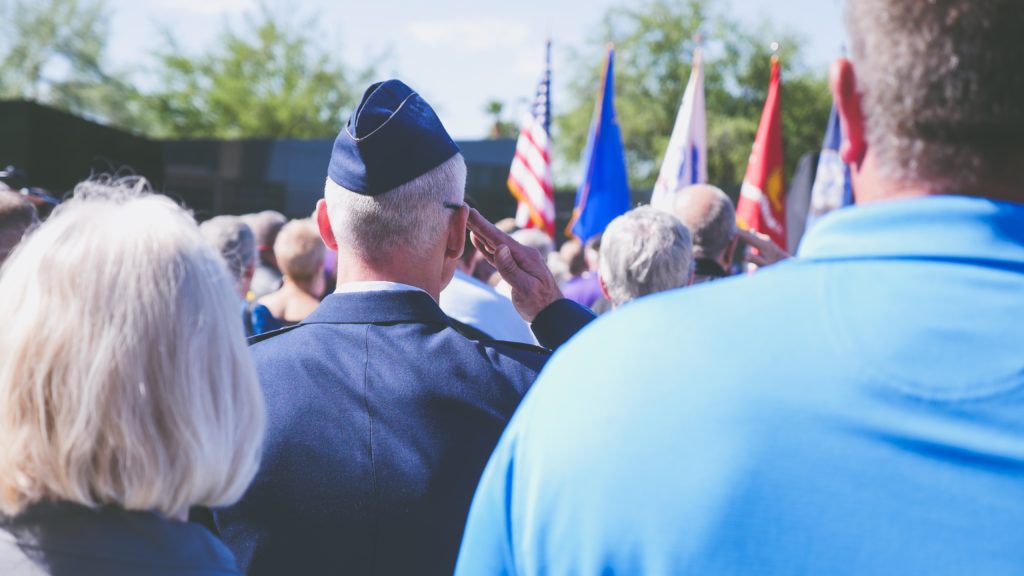 Veteran saluting flag